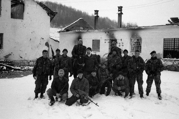 Foto 2: moslemische Kämpfer vor dem zerstörten serbischen Dorf Kravica 